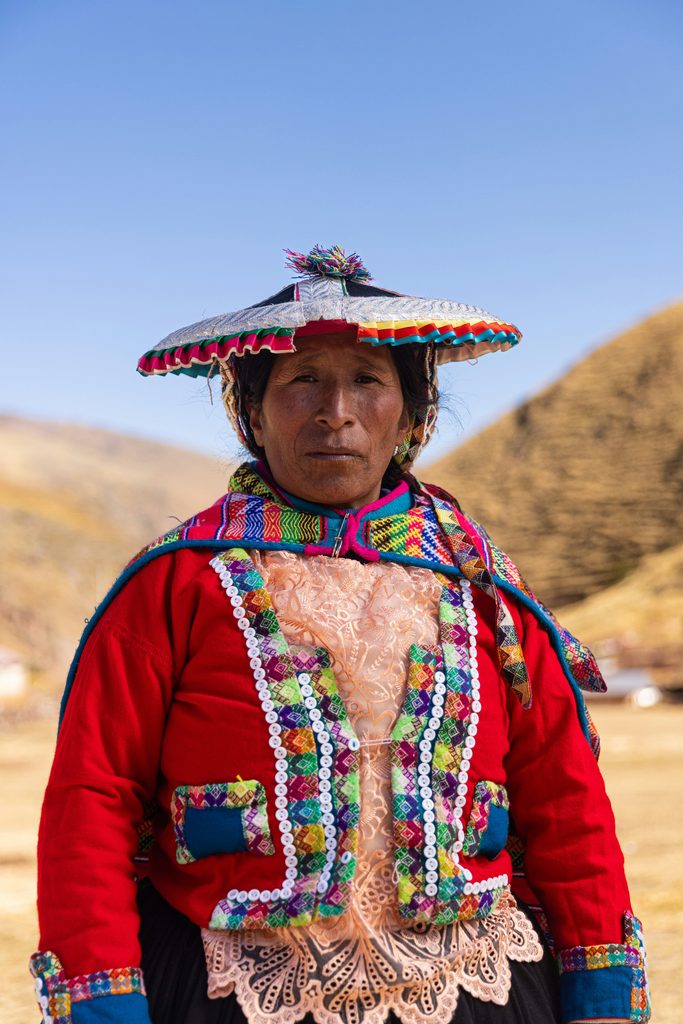 Portrait of a Quechua woman in her traditional ceremonial clothing in the middle of the mountains of Cuzco, Peru