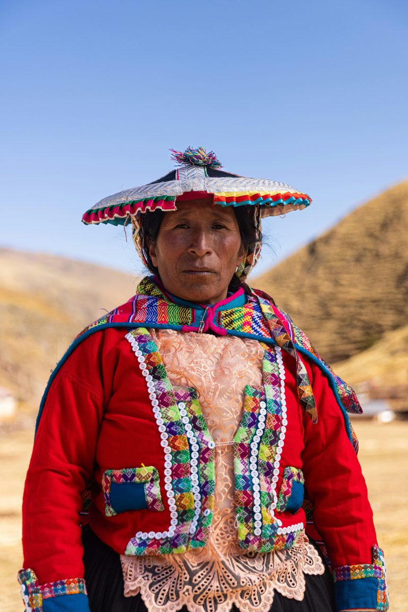 Portrait of a Quechua woman in her traditional ceremonial clothing in the middle of the mountains of Cuzco, Peru