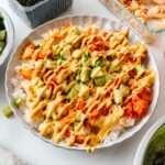 Up close on the saucy salmon rice bowl: tangy kimchi, creamy avocado, Kewpie and sriracha