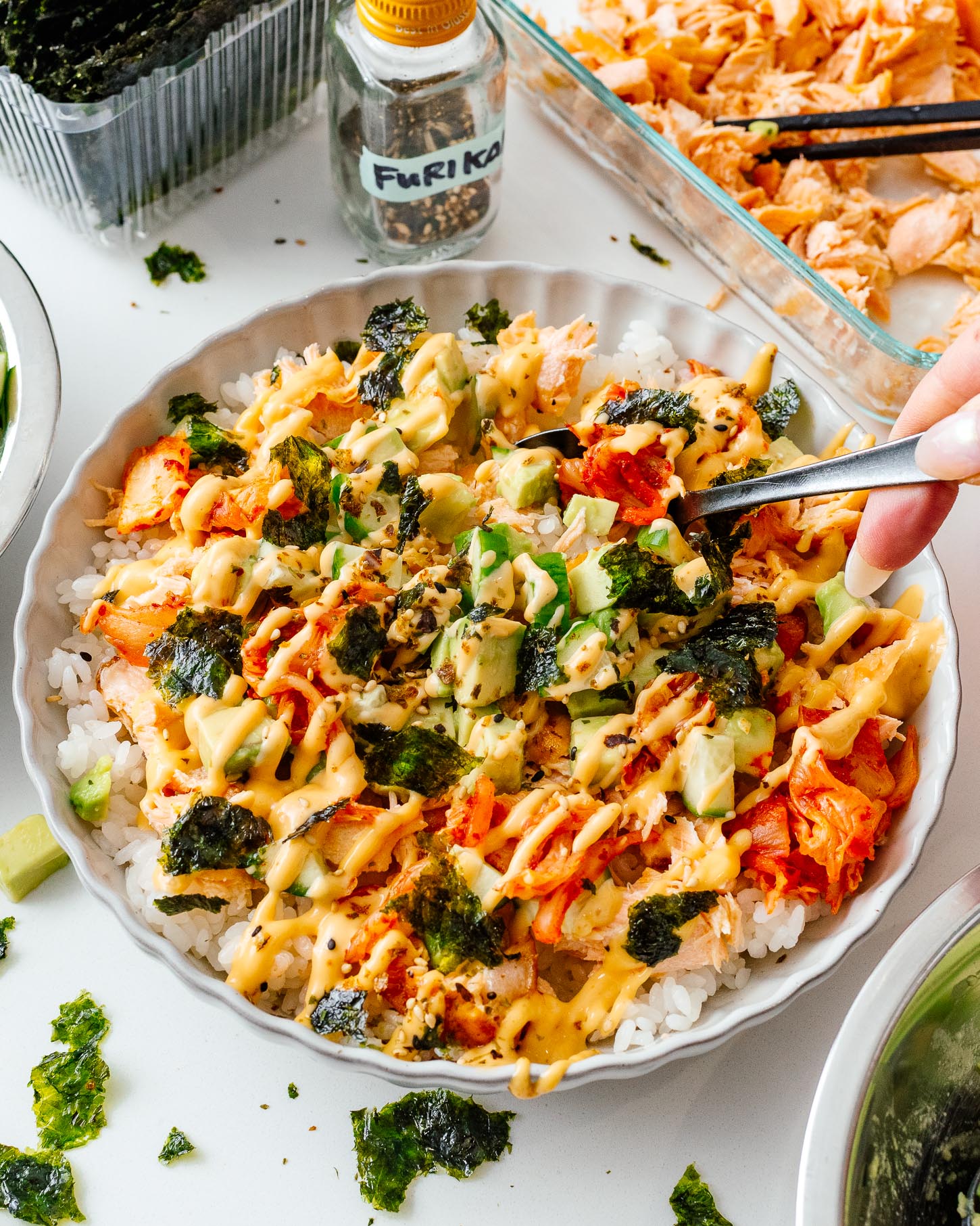 Digging into a saucy salmon rice bowl, with a spoon, the way it was meant to be eaten