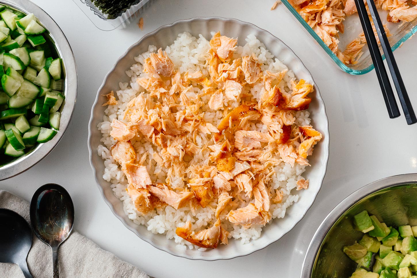 Tender flakes of leftover salmon piled onto warm, fluffy rice