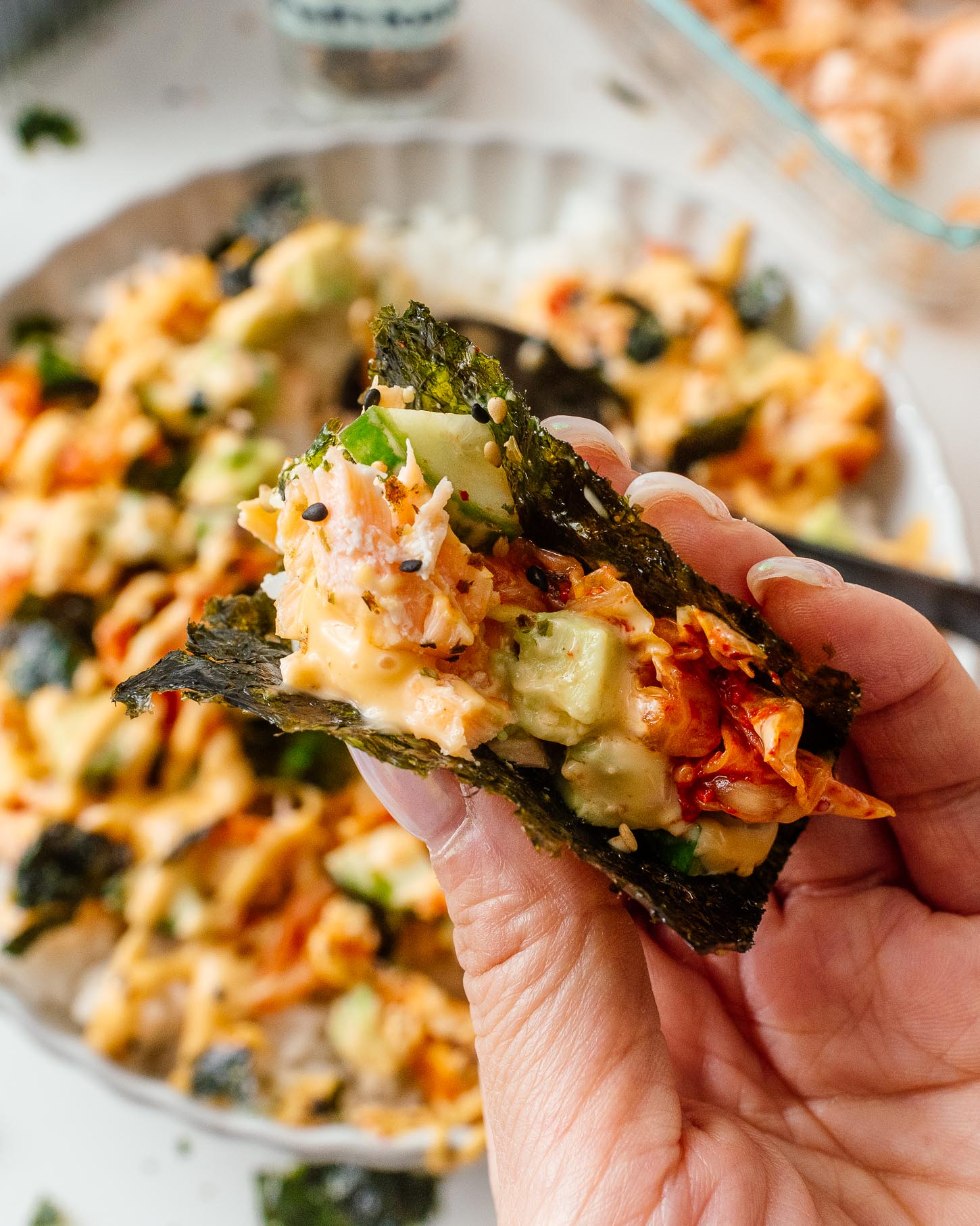 The perfect bite: crisp seaweed hugging salmon, rice, creamy avocado and tangy kimchi